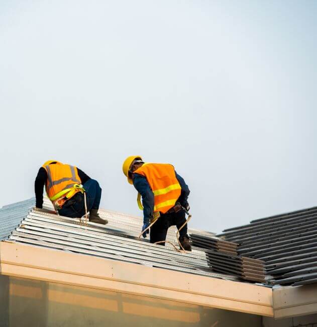 Two Bohannon Roofing contractors on a roof